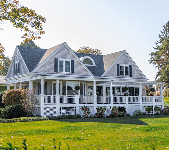 grey house with wrap-around porch