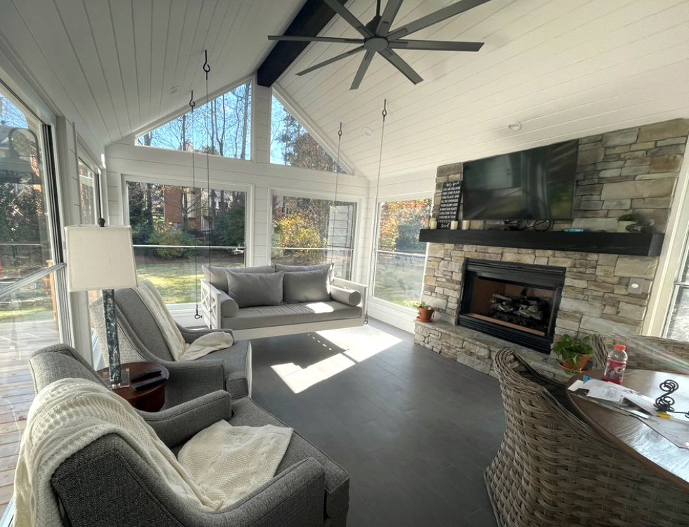 three season porch with fireplace and tv